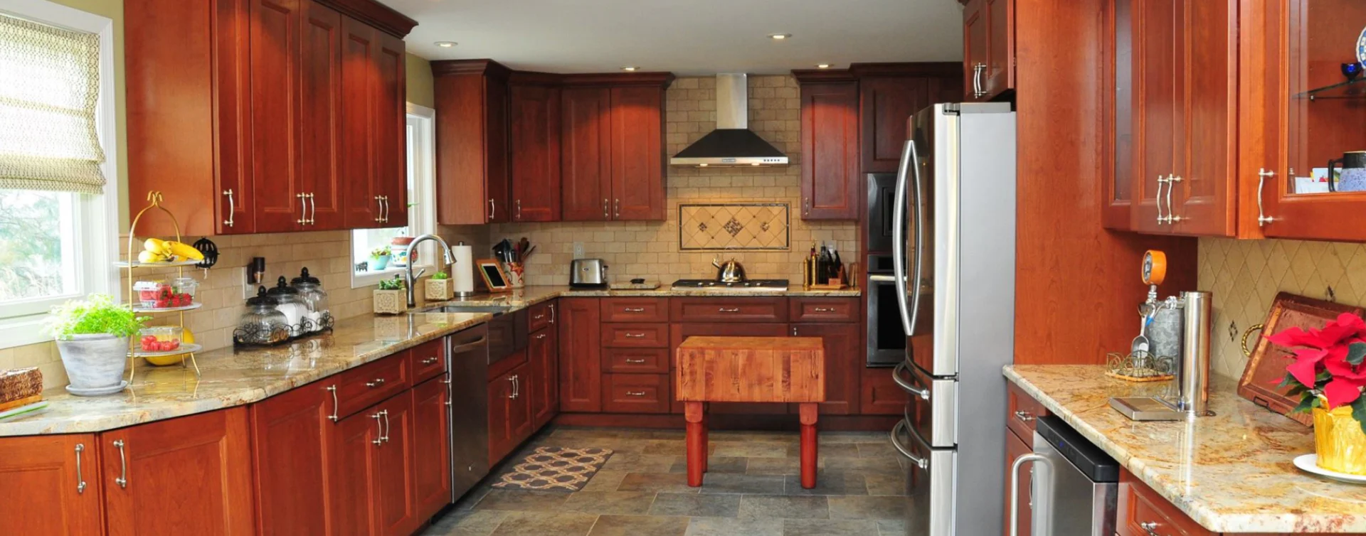 A kitchen with wooden cabinets and tile floors.