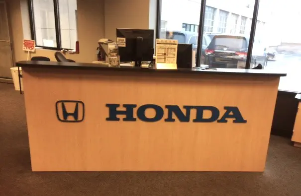 A honda sign is shown on the front desk.