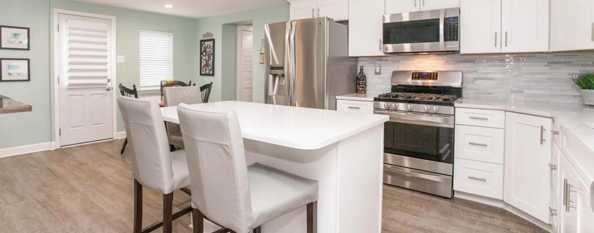 A kitchen with white cabinets and stainless steel appliances.